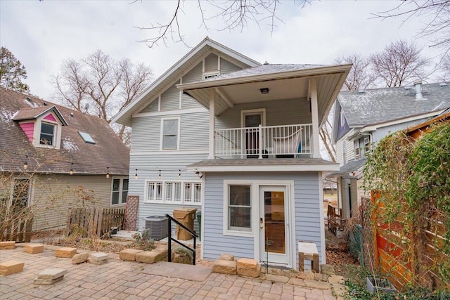 rear view of property with central air condition unit and a patio