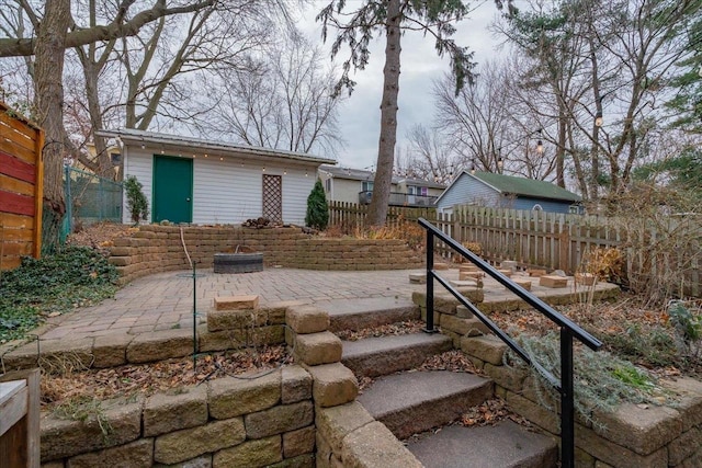 view of yard with an outbuilding, a patio area, and a fenced backyard