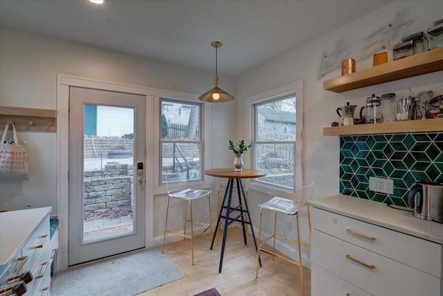 entryway with light wood-type flooring and baseboards