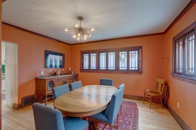 dining room featuring visible vents, crown molding, light wood-style flooring, and baseboards