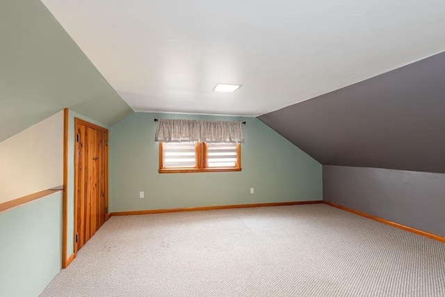 bonus room featuring carpet flooring, vaulted ceiling, and baseboards