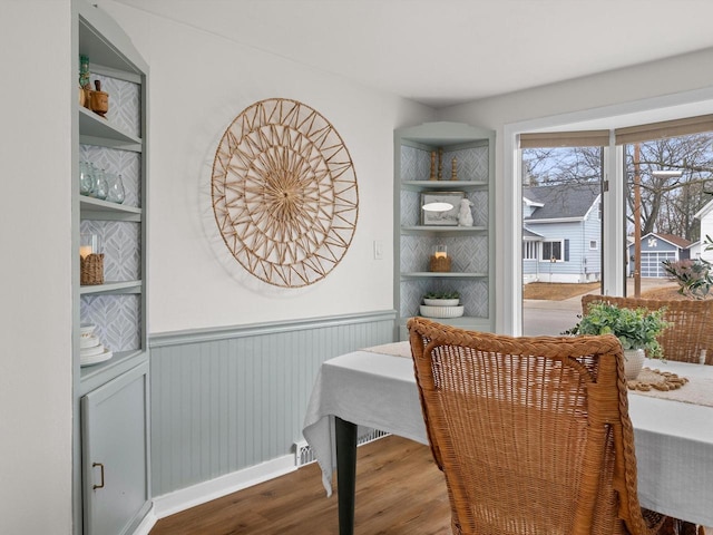 dining room featuring wood finished floors and wainscoting