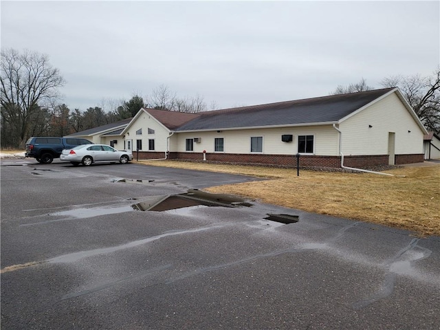 exterior space with a front lawn and brick siding