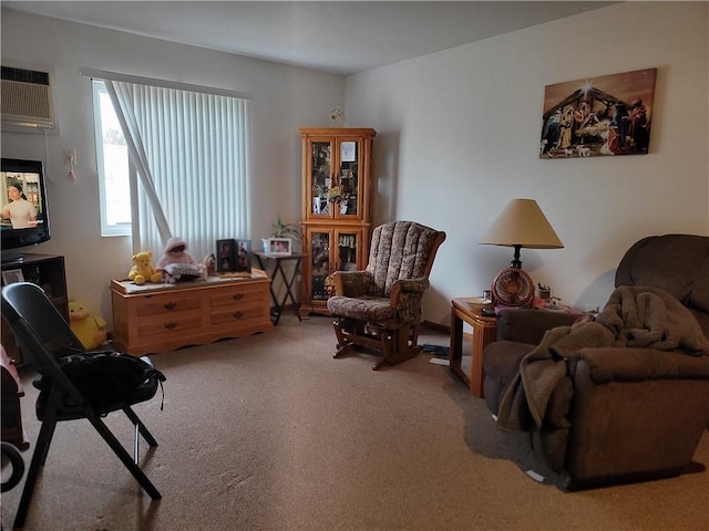 living area featuring carpet and a wall mounted AC