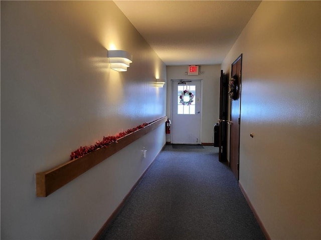 hall with carpet flooring and baseboards