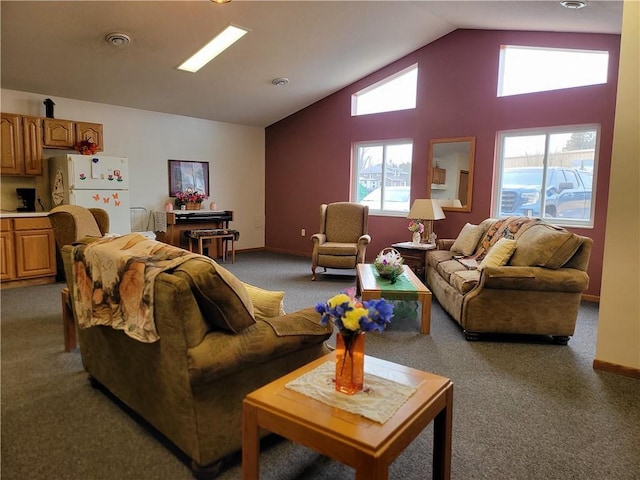 living room featuring high vaulted ceiling, baseboards, and light colored carpet