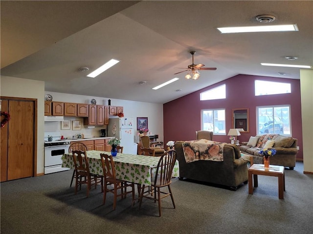 carpeted dining space with lofted ceiling, visible vents, a sink, and ceiling fan