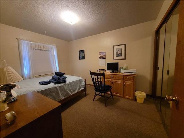 bedroom with dark colored carpet, a textured ceiling, and baseboards