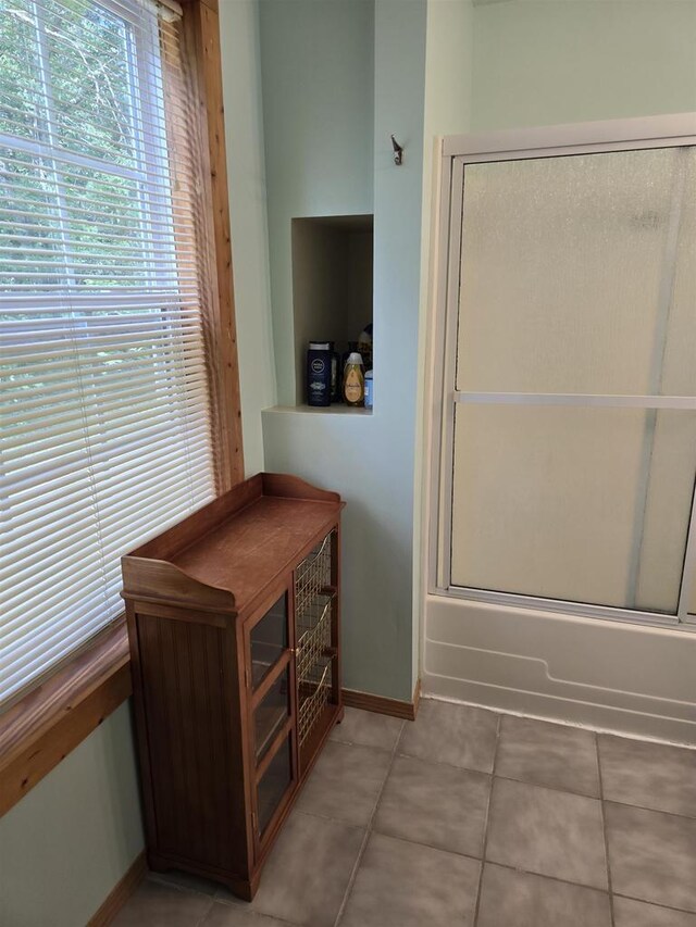 2838 W 3rd Dr, Oxford, WI 53952 - full bath with combined bath / shower with glass door, tile patterned floors, and baseboards