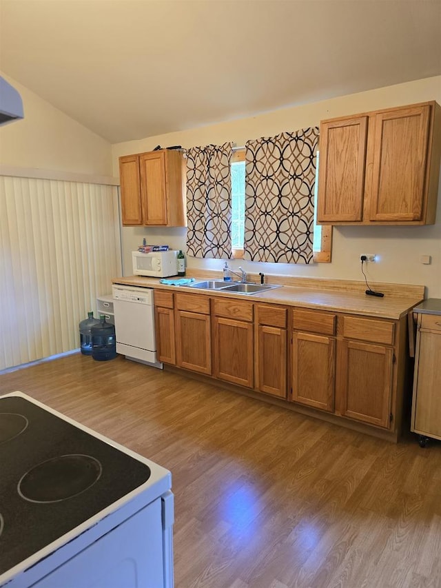 2838 W 3rd Dr, Oxford, WI 53952 - kitchen with white appliances, light wood-type flooring, brown cabinetry, light countertops, and lofted ceiling