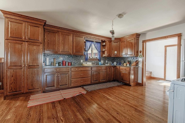 kitchen featuring brown cabinets, range, and wood finished floors