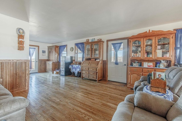 living room featuring light wood-style floors and a wainscoted wall