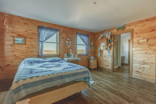 bedroom with wood walls and wood finished floors