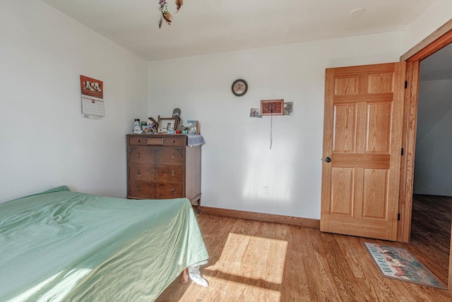 bedroom featuring baseboards and light wood-style floors