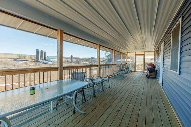 wooden terrace featuring outdoor dining space and a grill