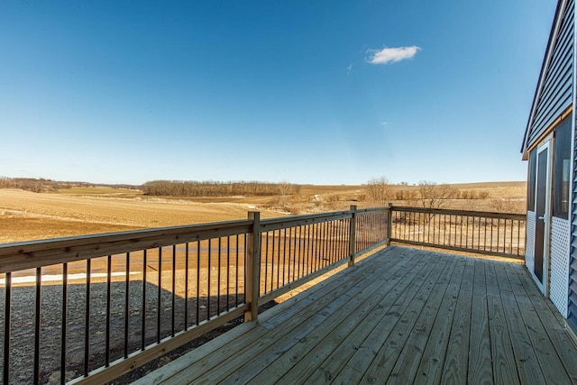 wooden deck with a rural view