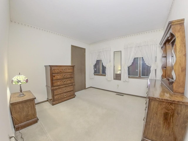 bedroom with visible vents and light colored carpet