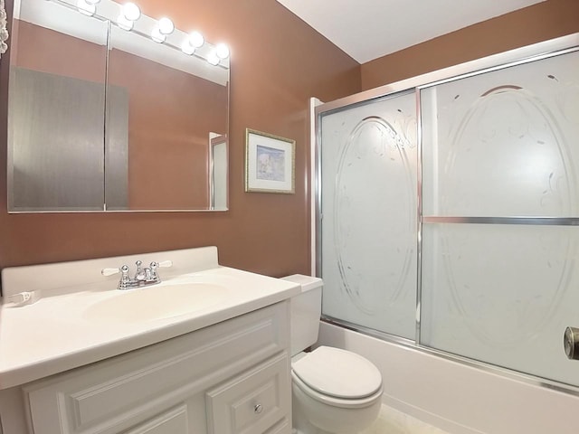 full bath with enclosed tub / shower combo, vanity, and toilet