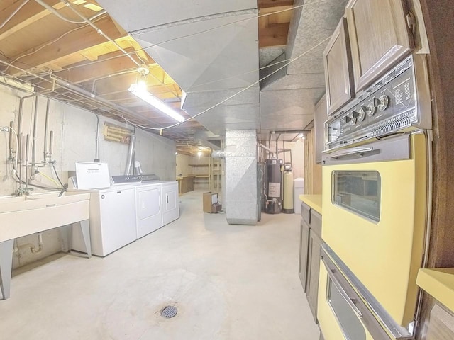 unfinished below grade area with water heater and washing machine and dryer