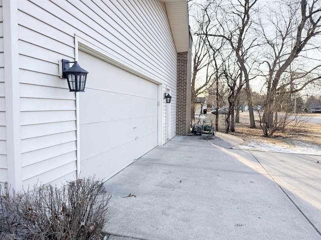 garage featuring concrete driveway