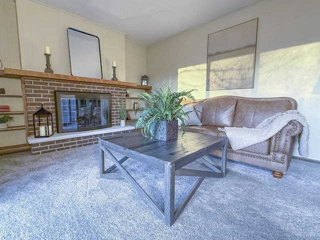 living room with a brick fireplace and carpet flooring