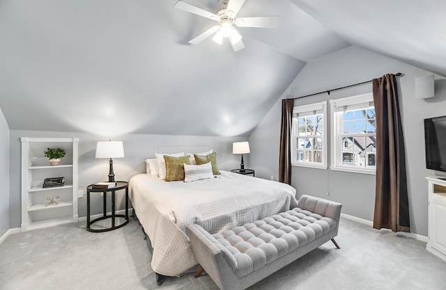 bedroom featuring baseboards, light colored carpet, a ceiling fan, and vaulted ceiling