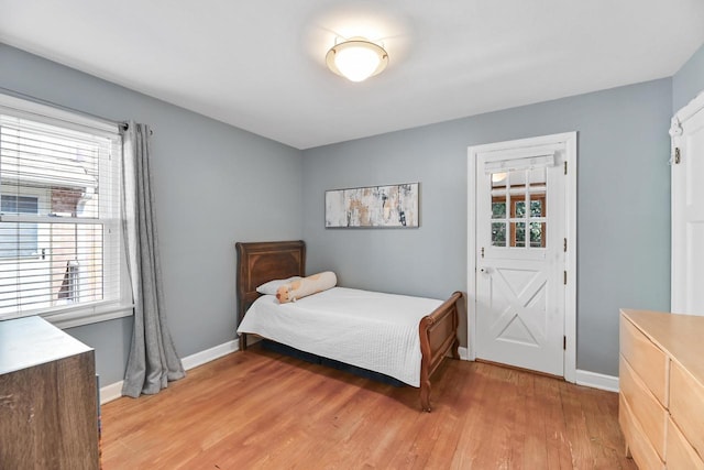 bedroom with light wood-style floors and baseboards