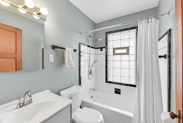 full bath featuring shower / bath combination with curtain, a healthy amount of sunlight, toilet, and vanity