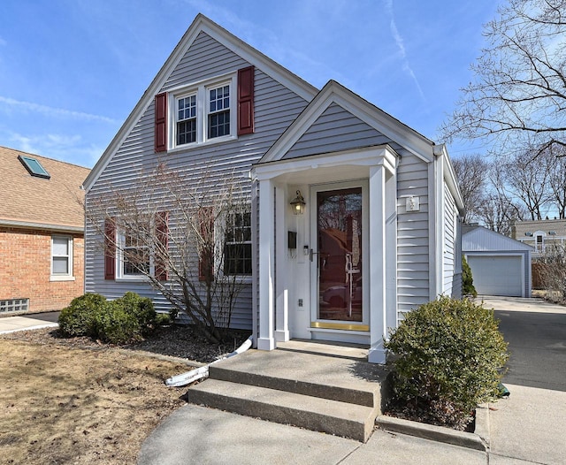 view of front of home featuring an outdoor structure and a detached garage