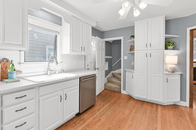 kitchen with open shelves, a sink, light countertops, white cabinets, and dishwasher