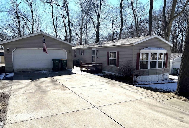 view of front of house featuring a detached garage and an outdoor structure