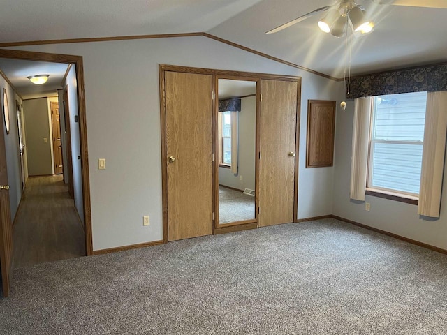 unfurnished bedroom with crown molding, carpet flooring, and vaulted ceiling