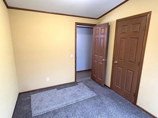 unfurnished bedroom with baseboards, carpet, and crown molding