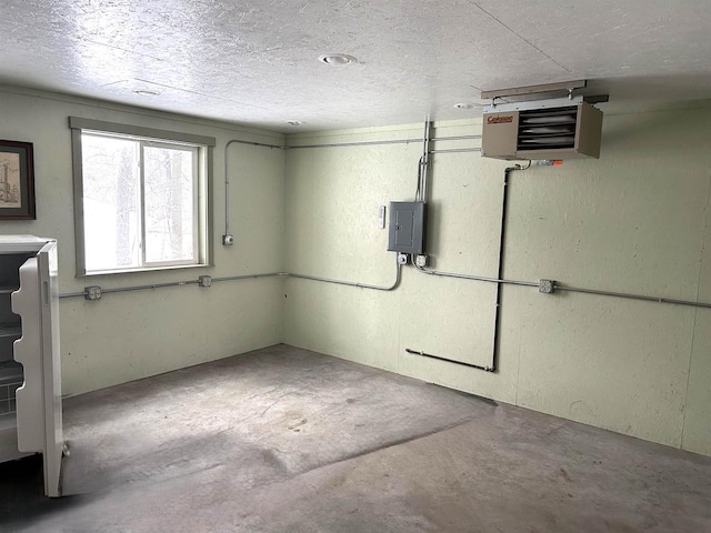 below grade area with electric panel, a heating unit, and a textured ceiling