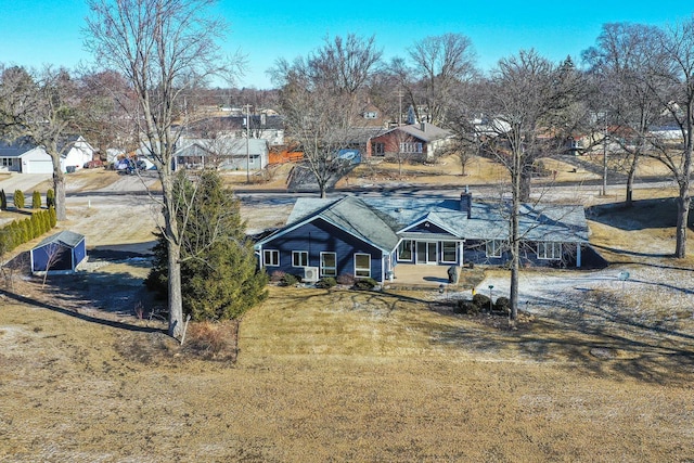 rear view of house with a lawn and a residential view