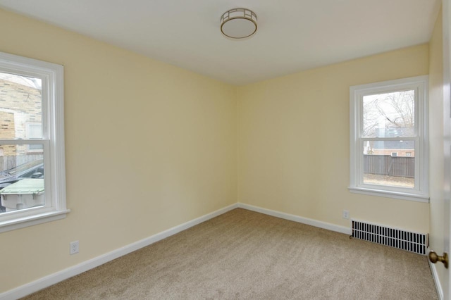 empty room featuring visible vents, plenty of natural light, and carpet flooring