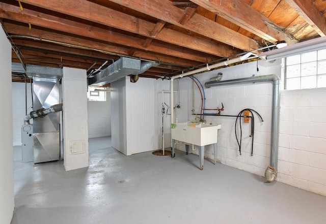 basement with a sink and heating unit