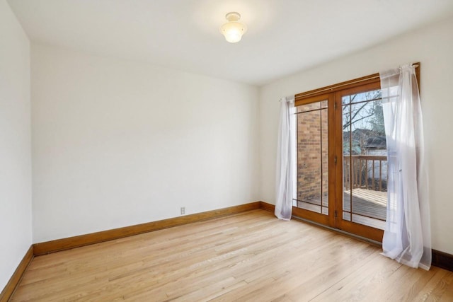 empty room with light wood-style flooring and baseboards