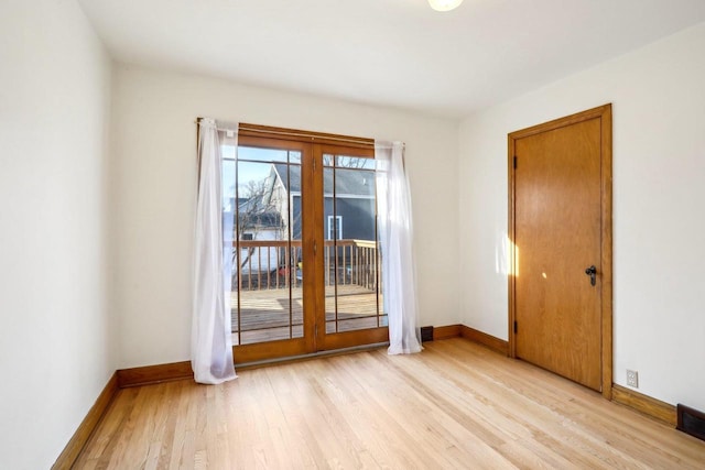 empty room with light wood-style flooring and baseboards