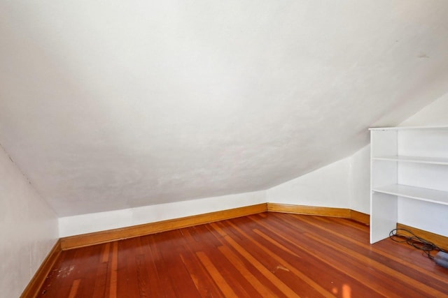 additional living space with lofted ceiling, baseboards, and hardwood / wood-style flooring