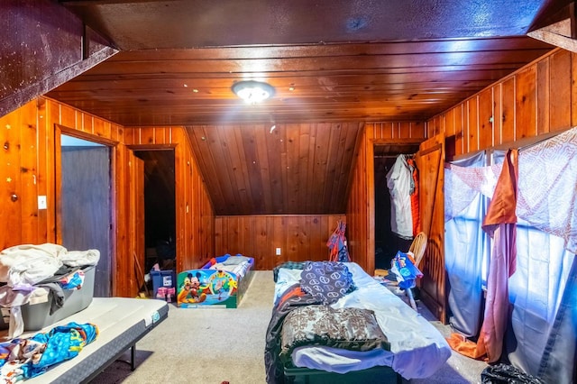 bedroom featuring lofted ceiling, wood walls, wooden ceiling, and carpet flooring