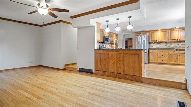 kitchen featuring dark countertops, light wood-type flooring, visible vents, and stainless steel appliances