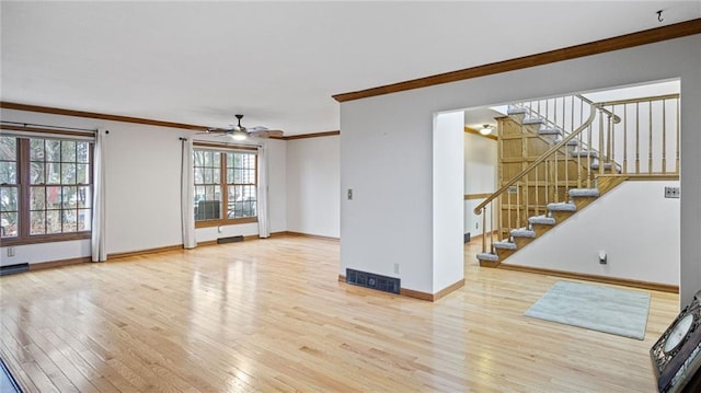 unfurnished living room featuring visible vents, baseboards, ornamental molding, wood finished floors, and stairs