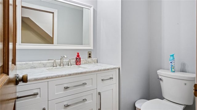 half bathroom featuring toilet and vanity