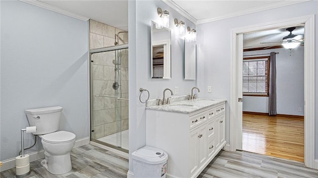 bathroom with crown molding, a sink, and wood finished floors