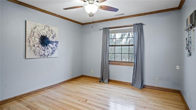 spare room featuring ceiling fan, ornamental molding, light wood-style flooring, and baseboards