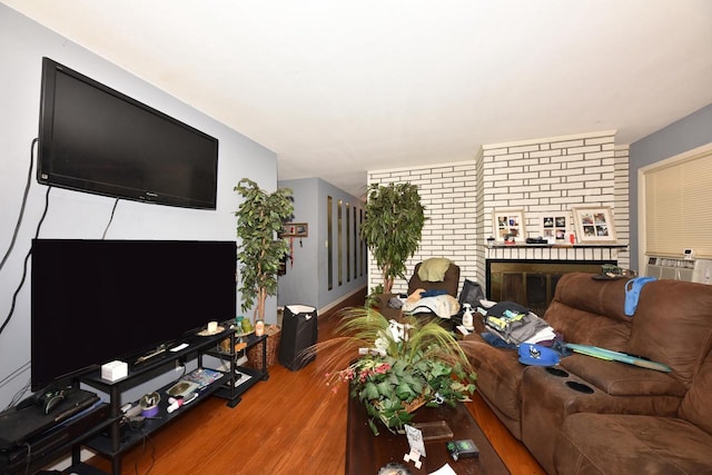 living room featuring a fireplace, wood finished floors, and cooling unit