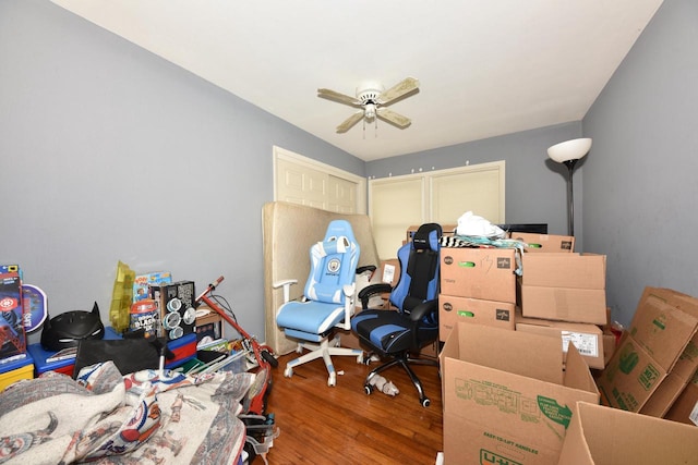 interior space with ceiling fan and wood finished floors