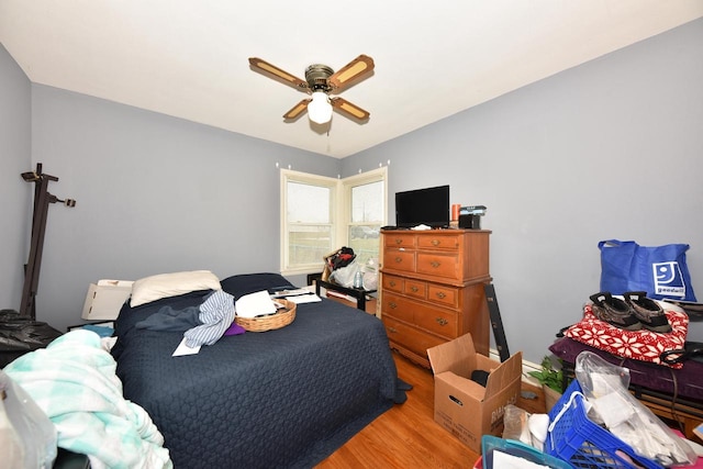 bedroom with ceiling fan and wood finished floors