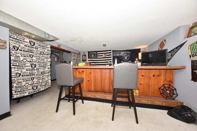 bar with concrete flooring and a bar